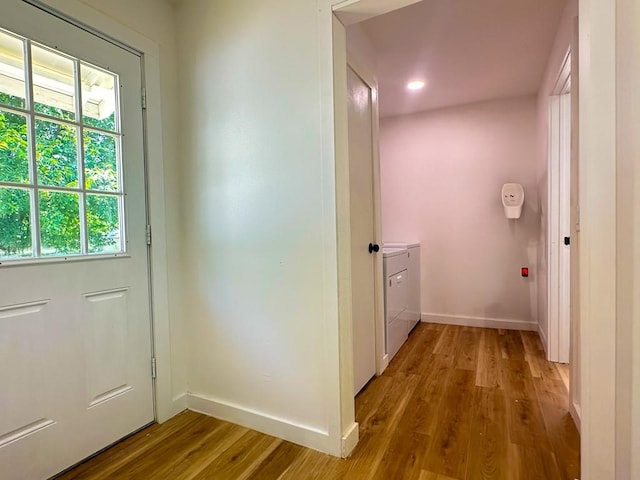 entryway with baseboards, a healthy amount of sunlight, and wood finished floors