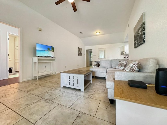 living room featuring vaulted ceiling, light tile patterned floors, and ceiling fan