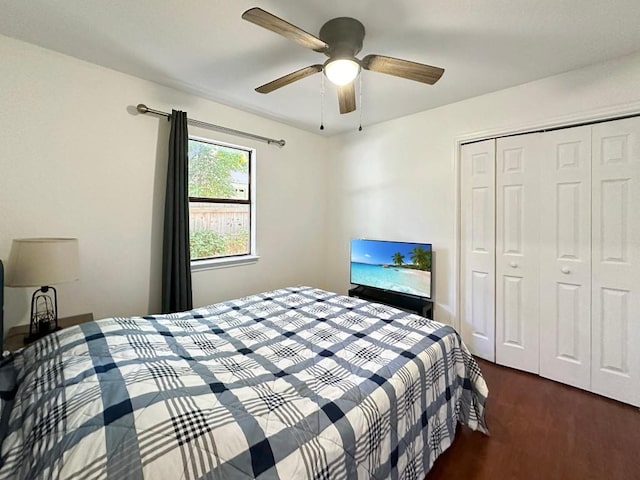 bedroom with dark hardwood / wood-style floors, a closet, and ceiling fan