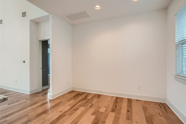 unfurnished room featuring a wealth of natural light and light wood-type flooring