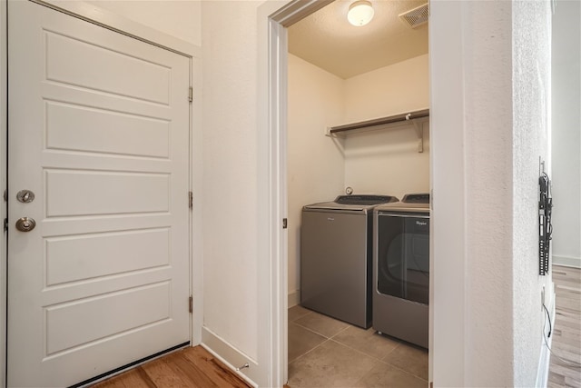 clothes washing area featuring washing machine and dryer