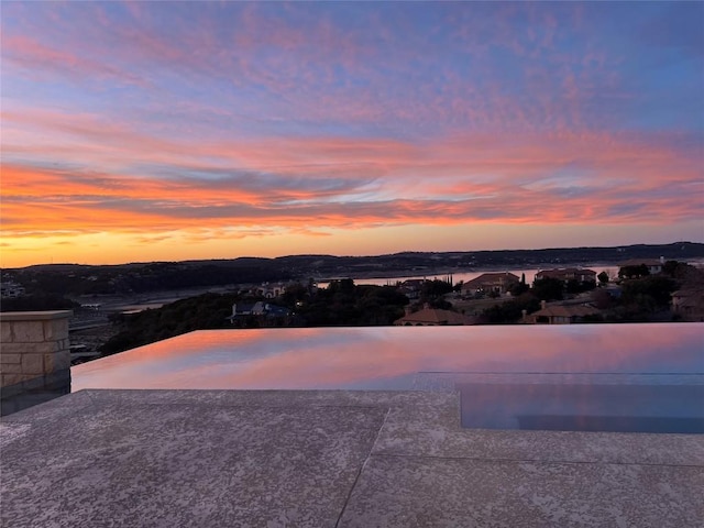 view of pool at dusk