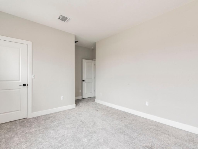 spare room with light colored carpet