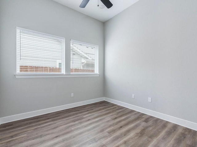 empty room with hardwood / wood-style flooring and ceiling fan