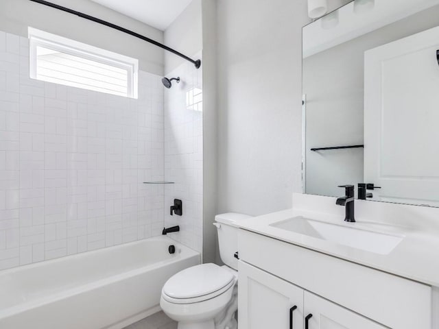 full bathroom featuring vanity, tiled shower / bath combo, and toilet