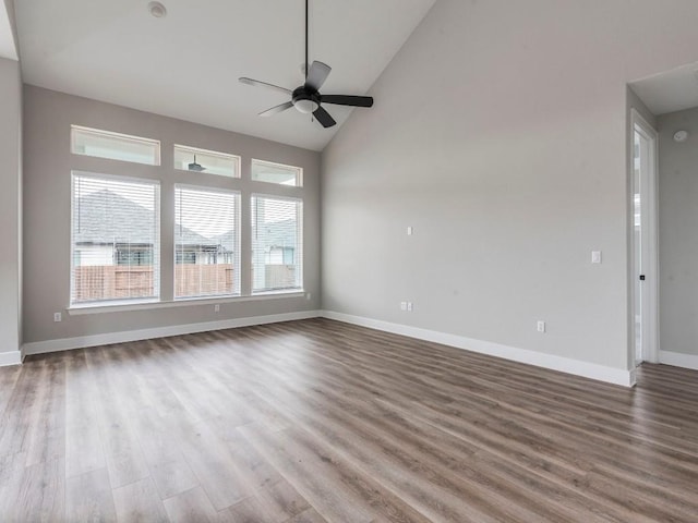 unfurnished living room with ceiling fan, high vaulted ceiling, and hardwood / wood-style floors