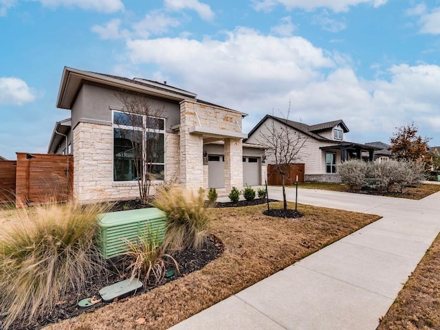 view of front of property featuring a garage and central AC unit