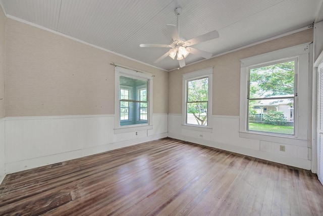 empty room with crown molding, ceiling fan, and wood-type flooring