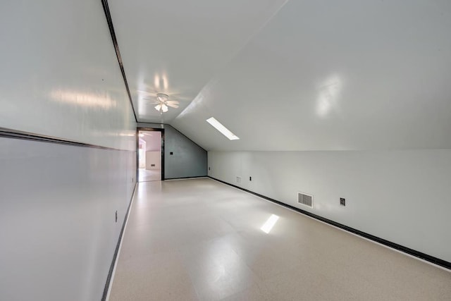 bonus room featuring ceiling fan and vaulted ceiling with skylight