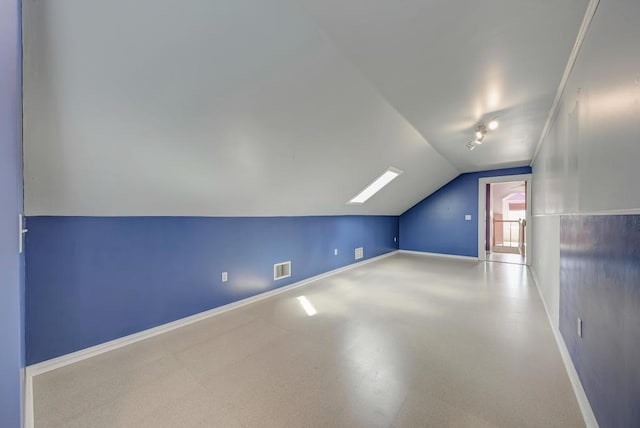 bonus room with lofted ceiling with skylight