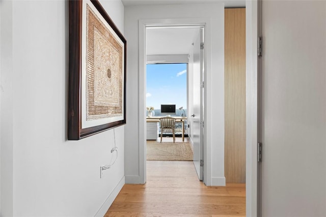 44 E Ave Unit 2310, Austin, TX 78701 - hallway featuring light wood-type flooring, baseboards, and a desk