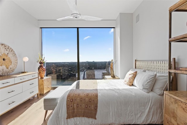 44 E Ave Unit 2310, Austin, TX 78701 - bedroom featuring wood finished floors, multiple windows, and ceiling fan