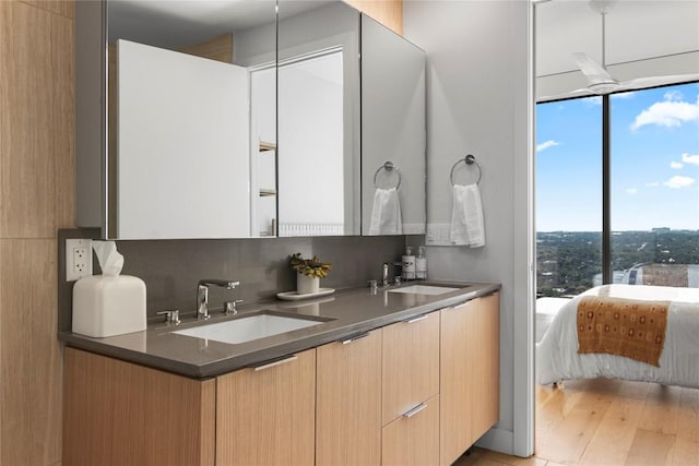 44 E Ave Unit 2310, Austin, TX 78701 - ensuite bathroom with double vanity and wood finished floors