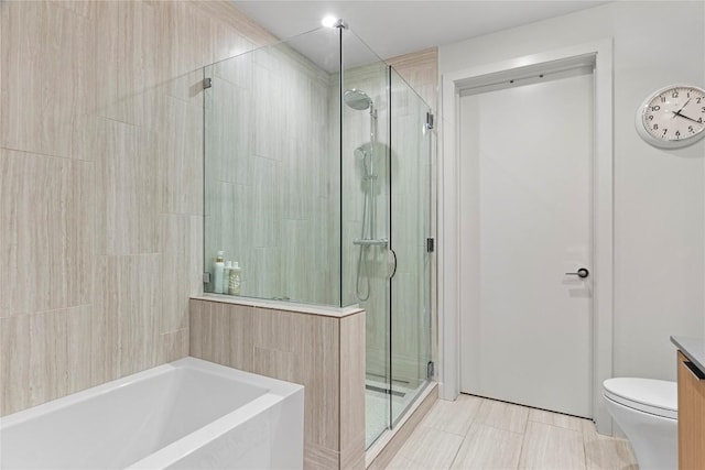 44 E Ave Unit 2310, Austin, TX 78701 - full bathroom with a stall shower, a bath, vanity, and toilet