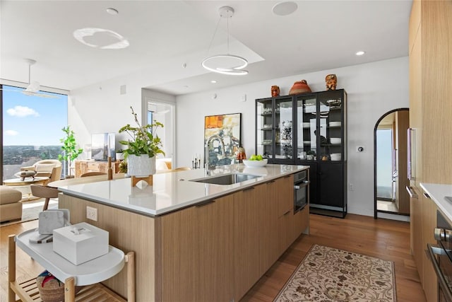44 E Ave Unit 2310, Austin, TX 78701 - kitchen with a sink, dark wood-type flooring, open floor plan, and light countertops