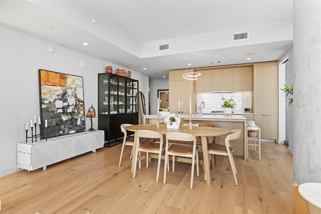 44 E Ave Unit 2310, Austin, TX 78701 - dining area featuring light wood-type flooring and recessed lighting