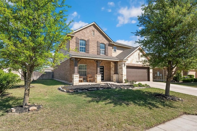 view of front of home featuring a porch, a garage, and a front yard