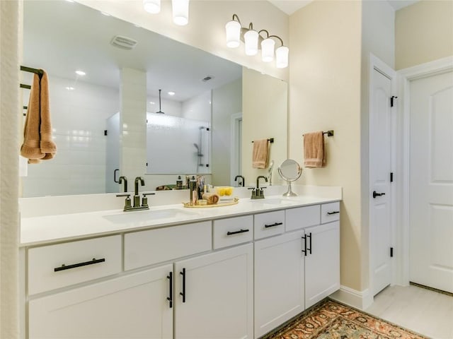 115 Lafayette St, Georgetown, TX 78633 - full bathroom featuring double vanity, tiled shower, and baseboards