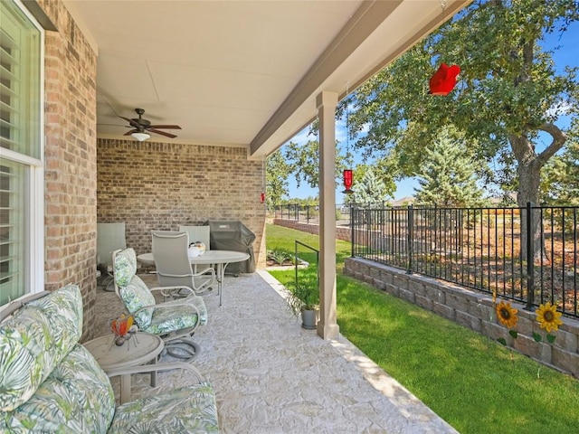 view of patio with a grill and ceiling fan