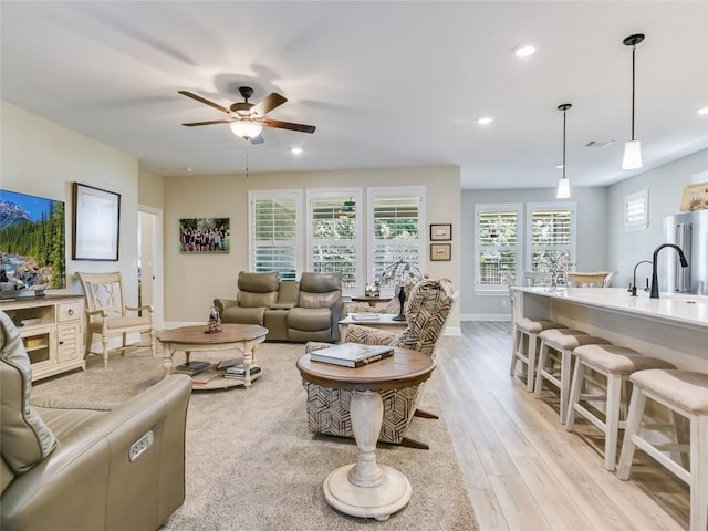 115 Lafayette St, Georgetown, TX 78633 - living room with light wood finished floors, ceiling fan, recessed lighting, and baseboards