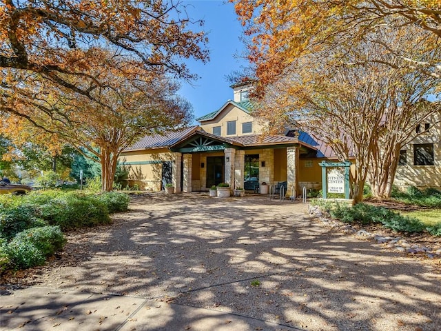 115 Lafayette St, Georgetown, TX 78633 - view of front of property with stone siding, a standing seam roof, covered porch, and metal roof