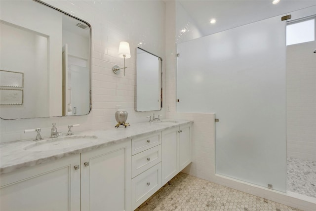 bathroom featuring tile walls, vanity, and walk in shower