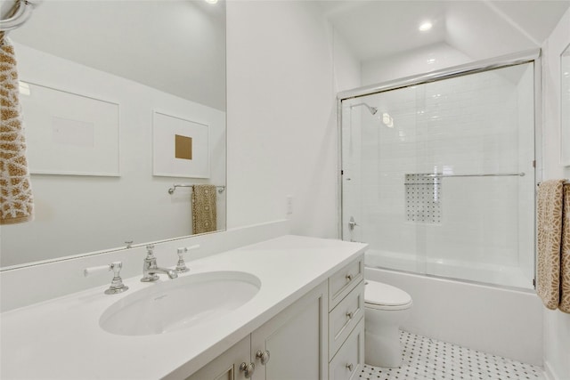 full bathroom featuring bath / shower combo with glass door, vanity, and toilet