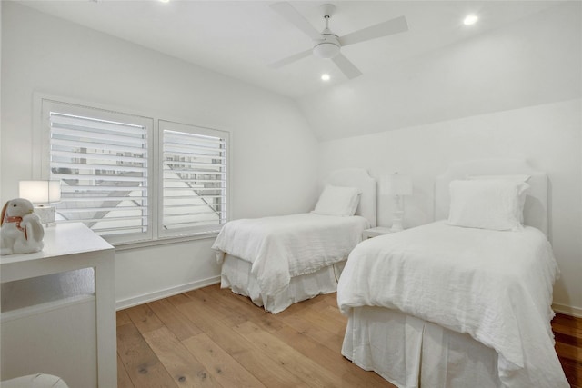 bedroom with vaulted ceiling, ceiling fan, and light hardwood / wood-style floors