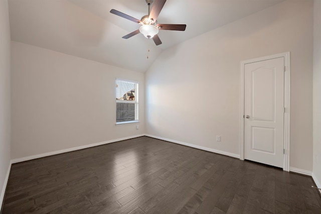 empty room with vaulted ceiling, ceiling fan, and dark hardwood / wood-style flooring