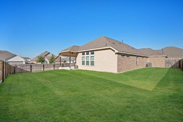 rear view of property with a lawn