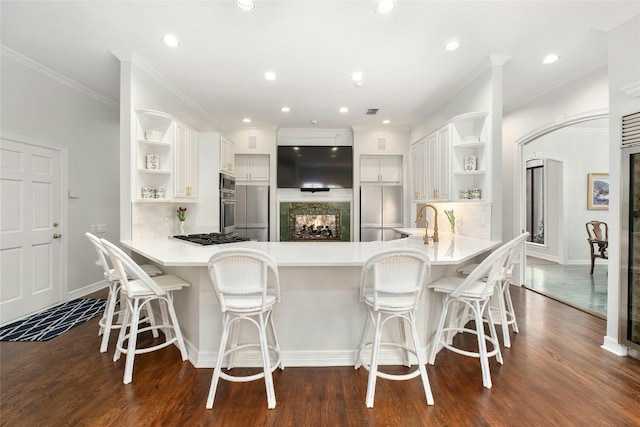 kitchen featuring white cabinetry, a kitchen breakfast bar, and kitchen peninsula