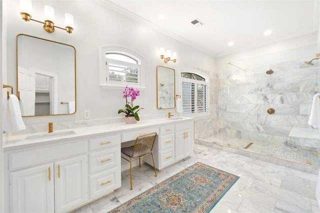 bathroom featuring a tile shower, vanity, and crown molding