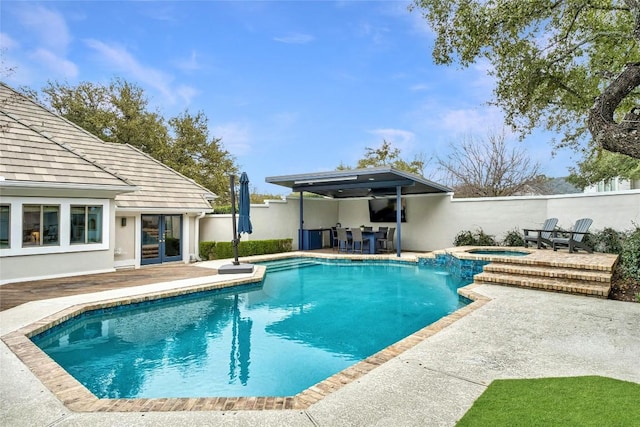 view of swimming pool with a patio and an in ground hot tub