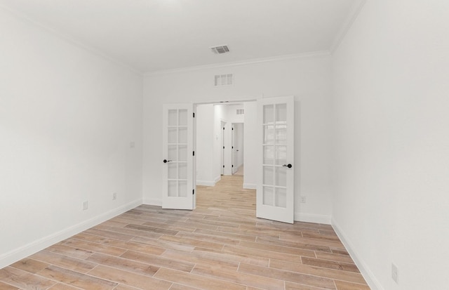 237 Silver Ridge Dr, Georgetown, TX 78633 - empty room featuring french doors, crown molding, light wood-style floors, and baseboards