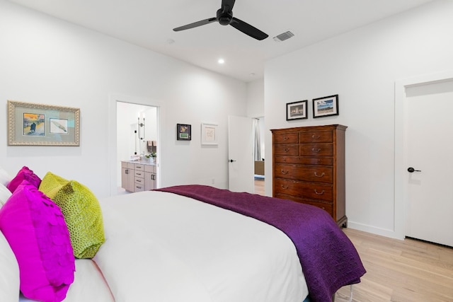 bedroom featuring light wood finished floors, recessed lighting, visible vents, ceiling fan, and ensuite bath