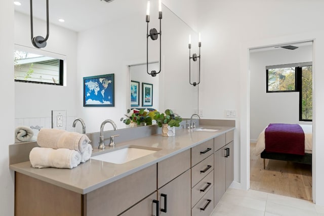 bathroom with a wealth of natural light, tile patterned flooring, and a sink