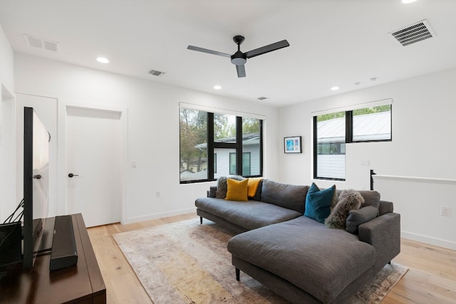 living area with light wood finished floors, plenty of natural light, and visible vents