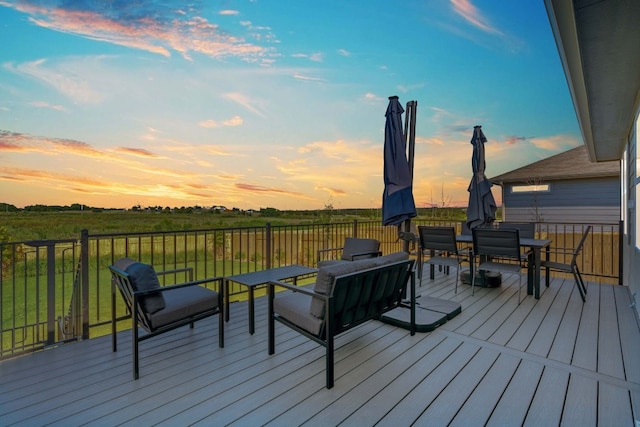 deck at dusk featuring an outdoor hangout area