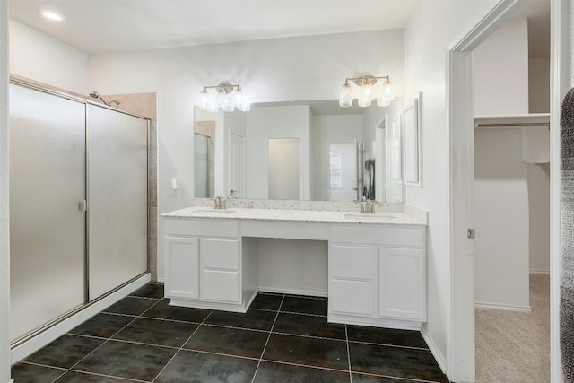 1228 Brenham Ln, Leander, TX 78641 - bathroom with a stall shower, double vanity, tile patterned floors, and a walk in closet