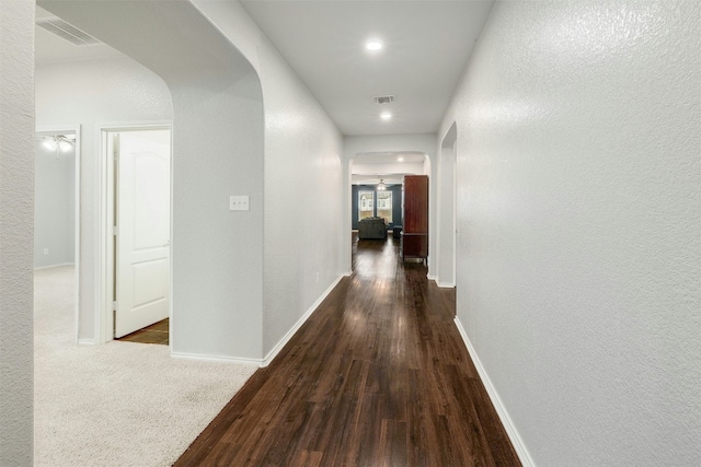 1228 Brenham Ln, Leander, TX 78641 - corridor with arched walkways, wood finished floors, baseboards, a textured wall, and recessed lighting
