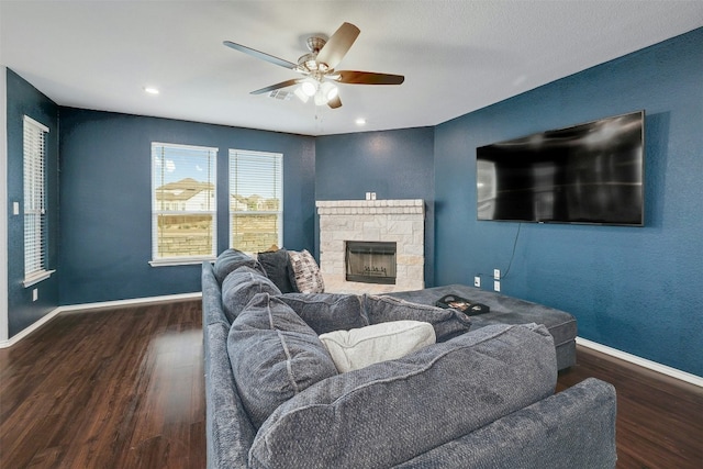 1228 Brenham Ln, Leander, TX 78641 - living area featuring wood finished floors, ceiling fan, baseboards, a stone fireplace, and recessed lighting