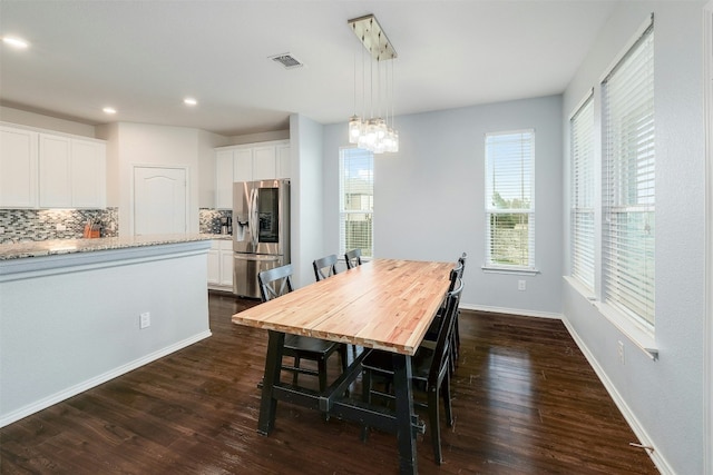 1228 Brenham Ln, Leander, TX 78641 - dining space with a chandelier, dark wood-type flooring, recessed lighting, and baseboards