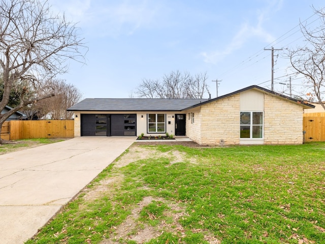 single story home featuring a garage and a front lawn