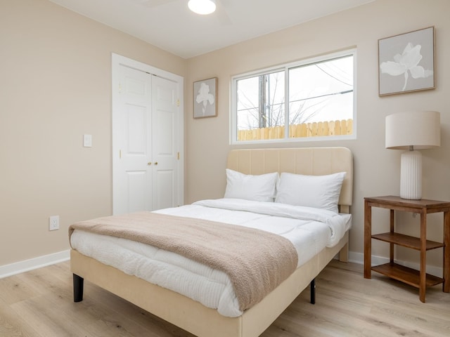 8901 Pointer Ln, Austin, TX 78758 - bedroom featuring a closet, light wood-type flooring, baseboards, and a ceiling fan
