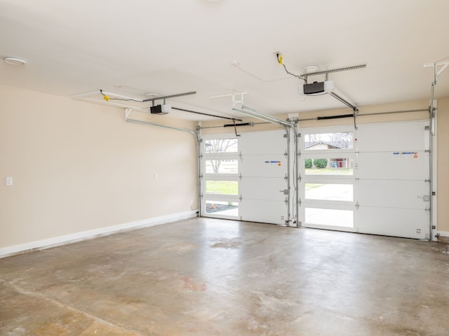 8901 Pointer Ln, Austin, TX 78758 - garage featuring a garage door opener and baseboards