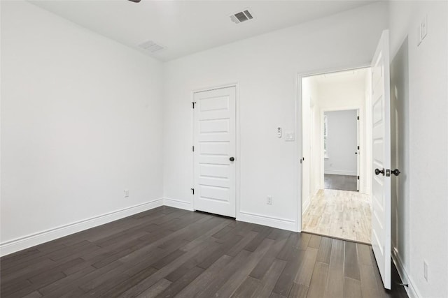 unfurnished room with dark hardwood / wood-style floors