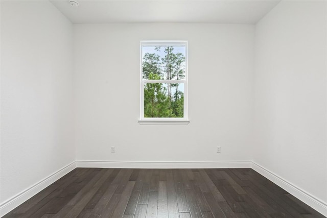 spare room with dark hardwood / wood-style flooring