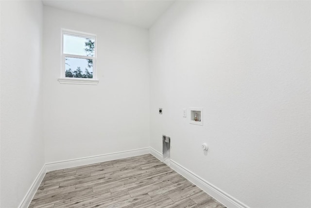clothes washing area with hookup for a gas dryer, washer hookup, hookup for an electric dryer, and light hardwood / wood-style flooring