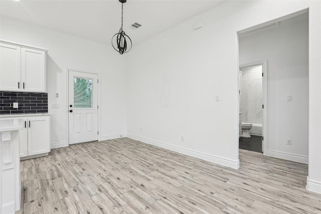 unfurnished dining area with light hardwood / wood-style flooring