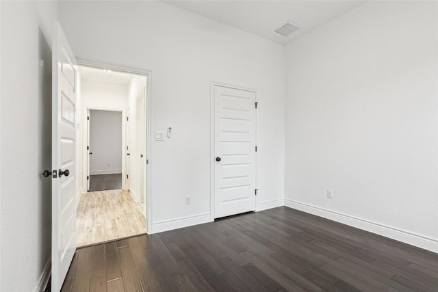 empty room featuring dark hardwood / wood-style flooring